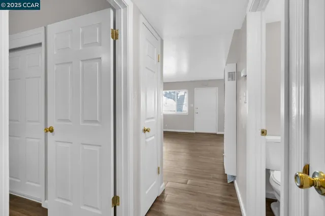 a view of a hallway with wooden floor