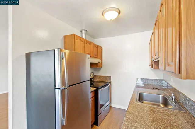 a kitchen with a refrigerator and a sink