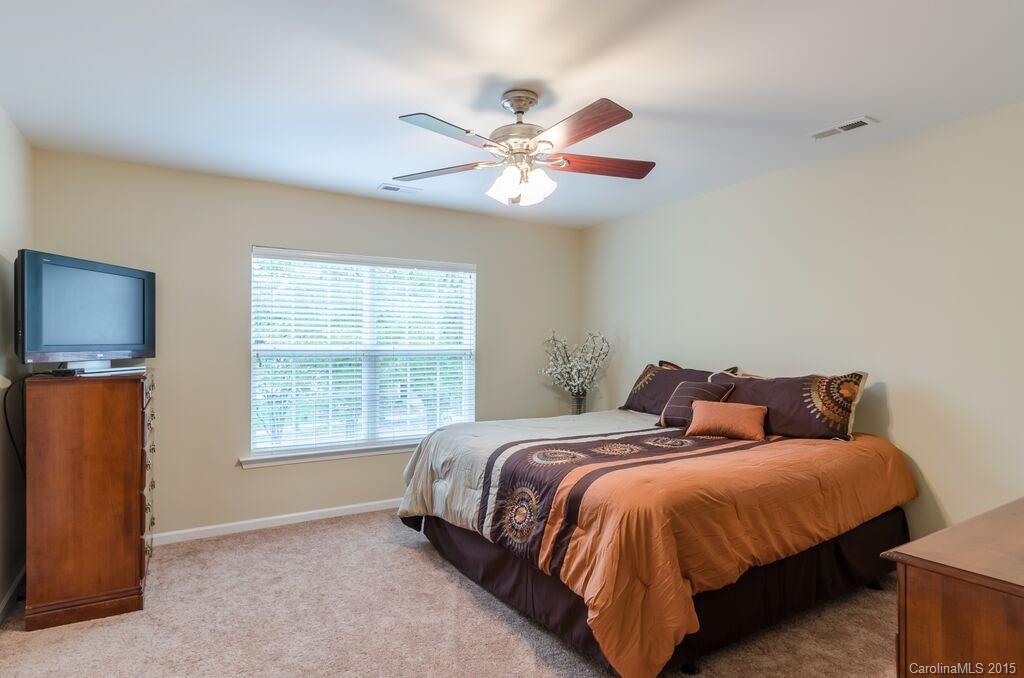 10012 Caldwell Depot Road Cornelius, NC 28031 - Photo 11 of 20 a spacious bedroom with a bed and a window