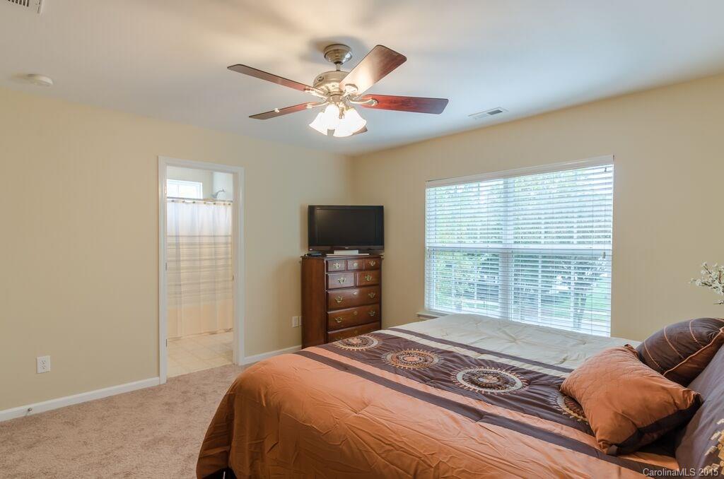 10012 Caldwell Depot Road Cornelius, NC 28031 - Photo 12 of 20 a bedroom with a bed and wooden floor