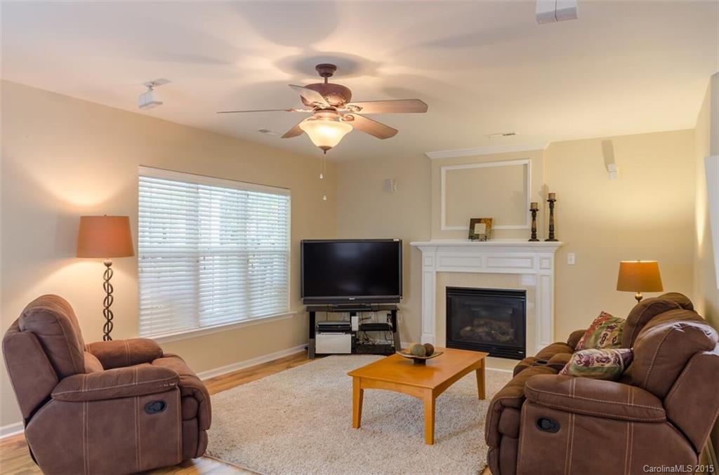 10012 Caldwell Depot Road Cornelius, NC 28031 - Photo 5 of 20 a living room with furniture a fireplace and a flat screen tv