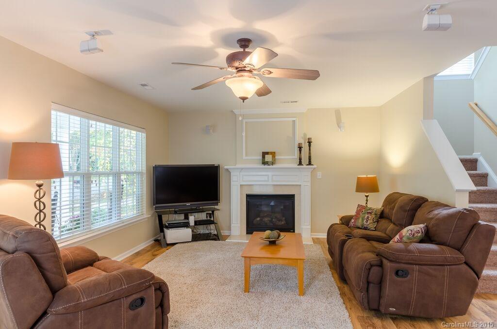 10012 Caldwell Depot Road Cornelius, NC 28031 - Photo 6 of 20 a living room with furniture ceiling fan and a fireplace