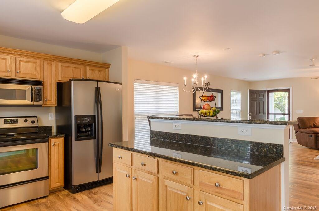 10012 Caldwell Depot Road Cornelius, NC 28031 - Photo 9 of 20 a kitchen with stainless steel appliances granite countertop a refrigerator and a stove