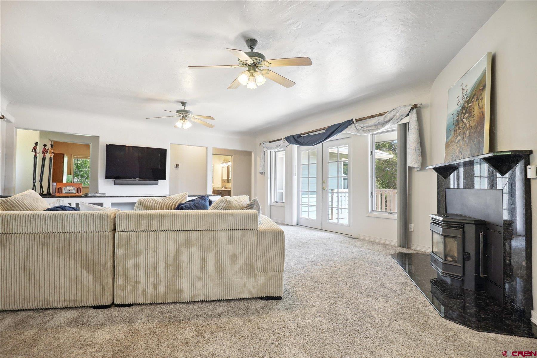 1200 North Dolores Road Cortez, CO 81321 - Photo 17 of 34 a living room with furniture and a flat screen tv
