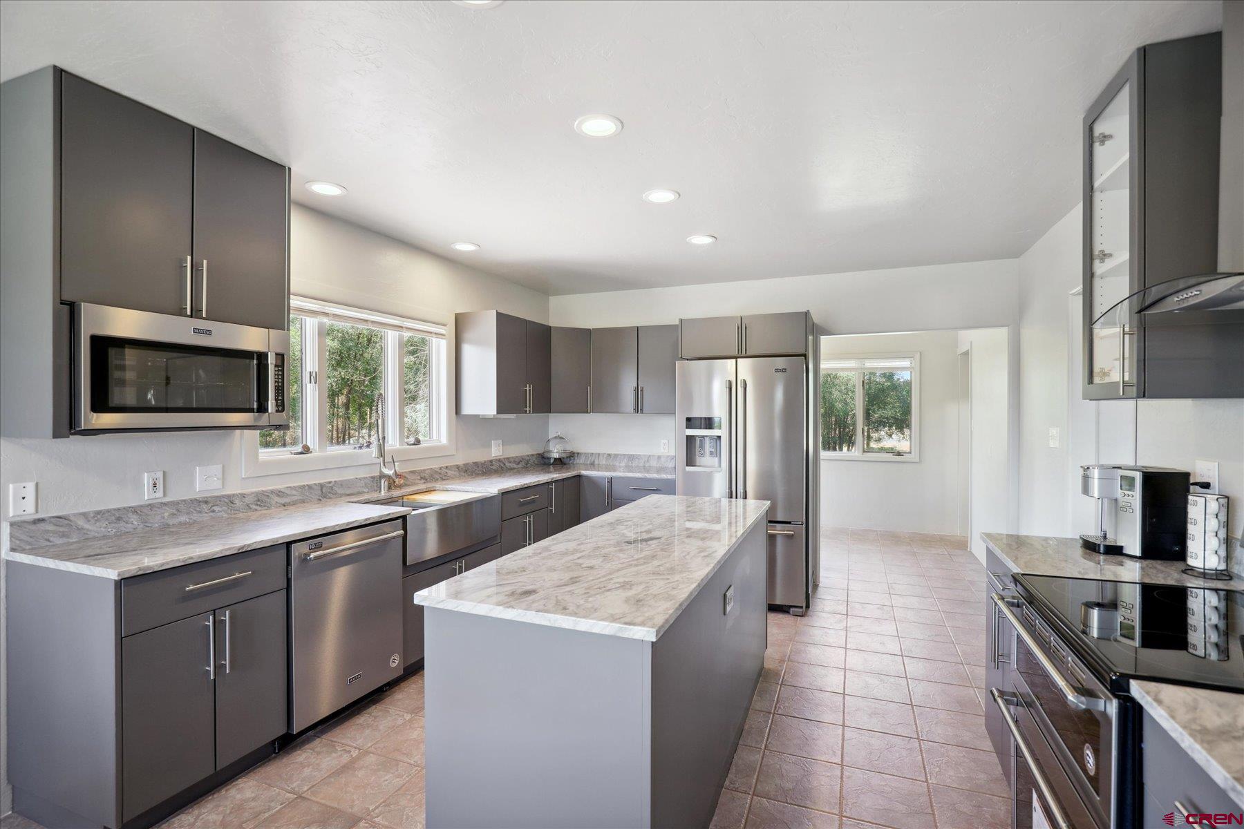 1200 North Dolores Road Cortez, CO 81321 - Photo 2 of 34 a kitchen with a sink stove and refrigerator