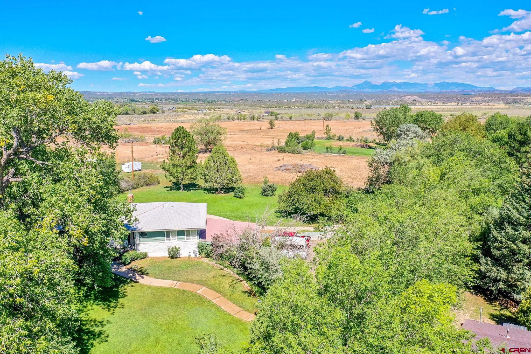 1200 North Dolores Road Cortez, CO 81321 - Photo 4 of 34 a view of a lake from a yard