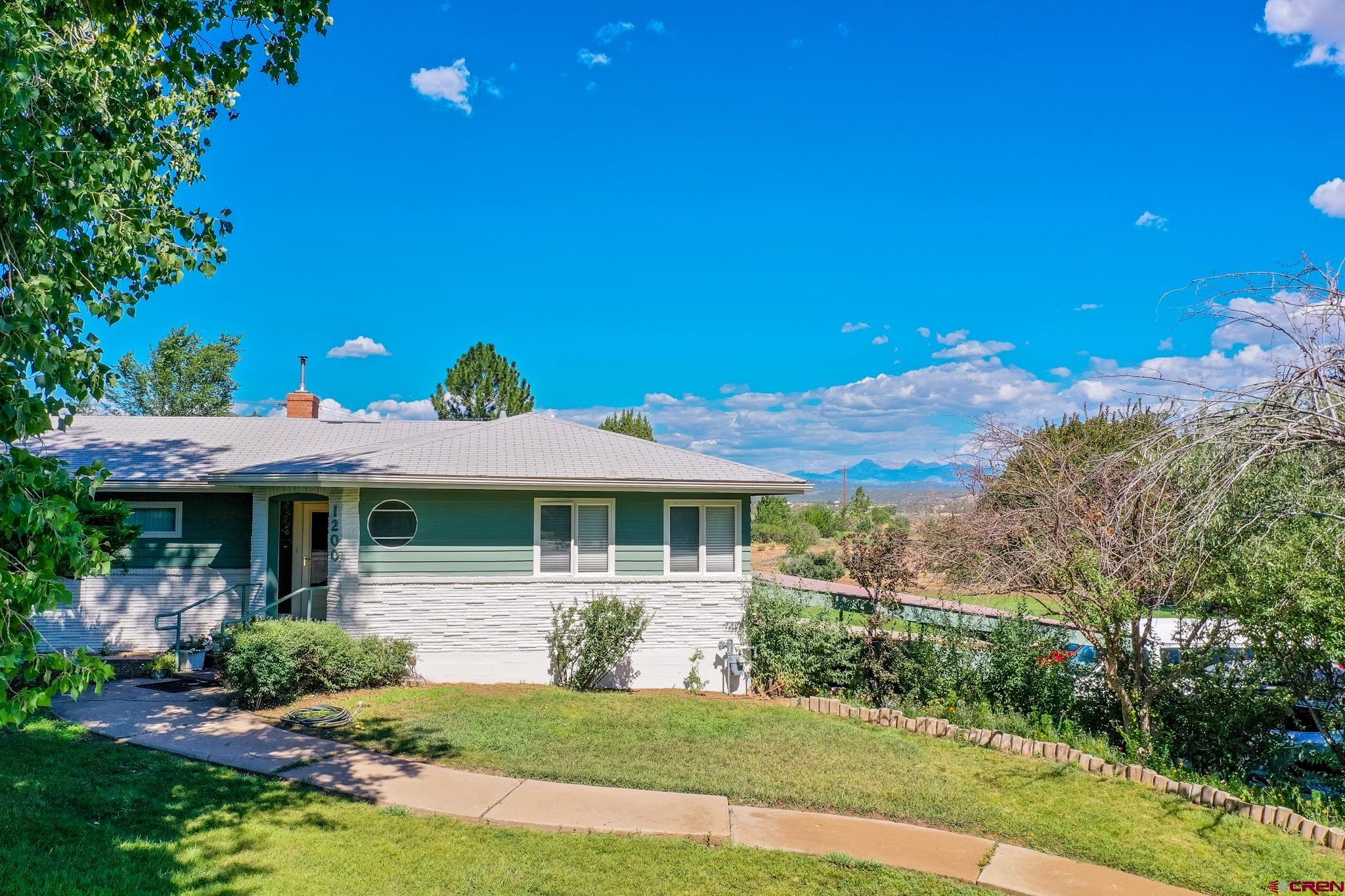 1200 North Dolores Road Cortez, CO 81321 - Photo 8 of 34 a front view of a house with a yard