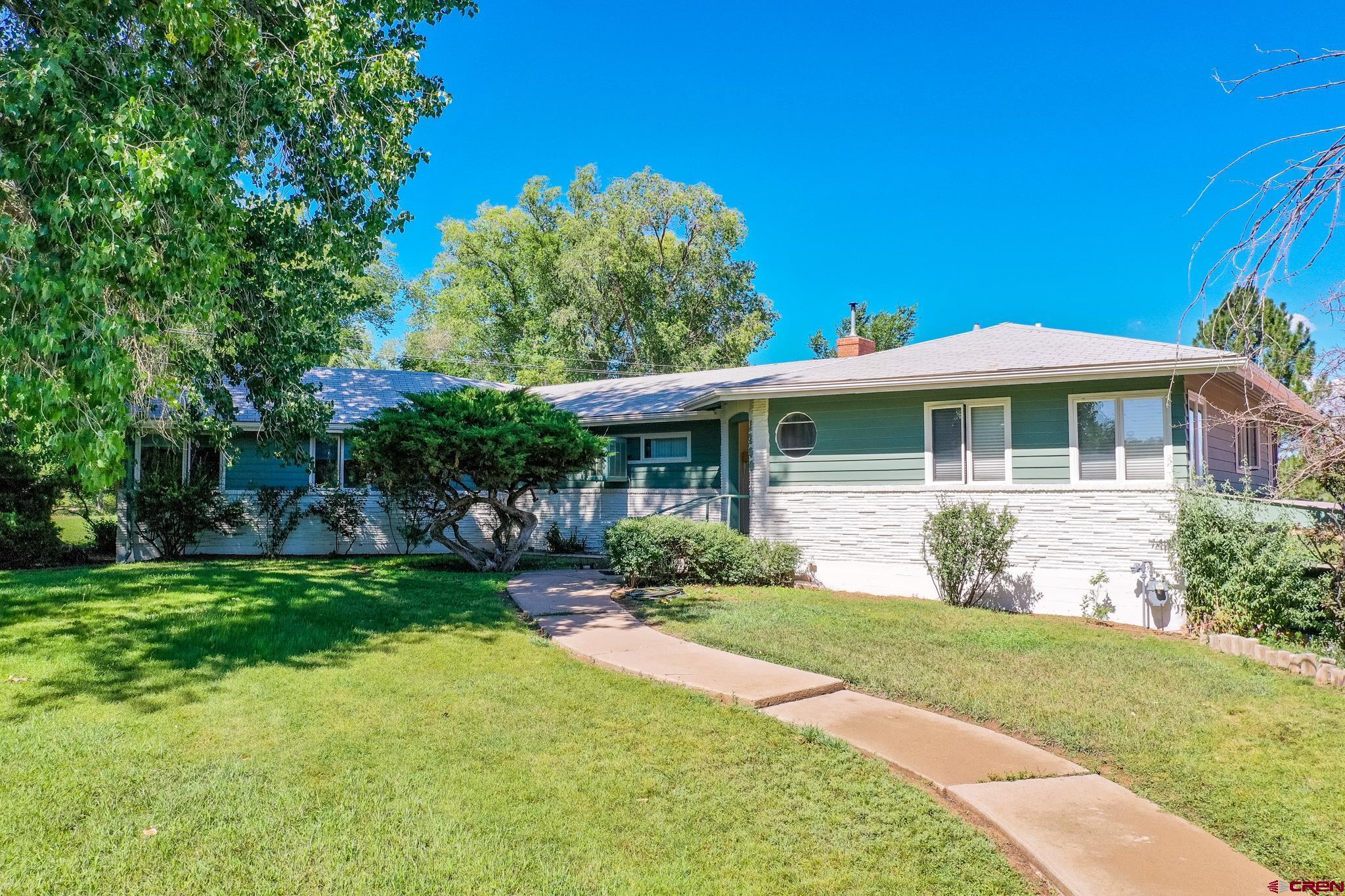 1200 North Dolores Road Cortez, CO 81321 - Photo 9 of 34 a front view of a house with a garden