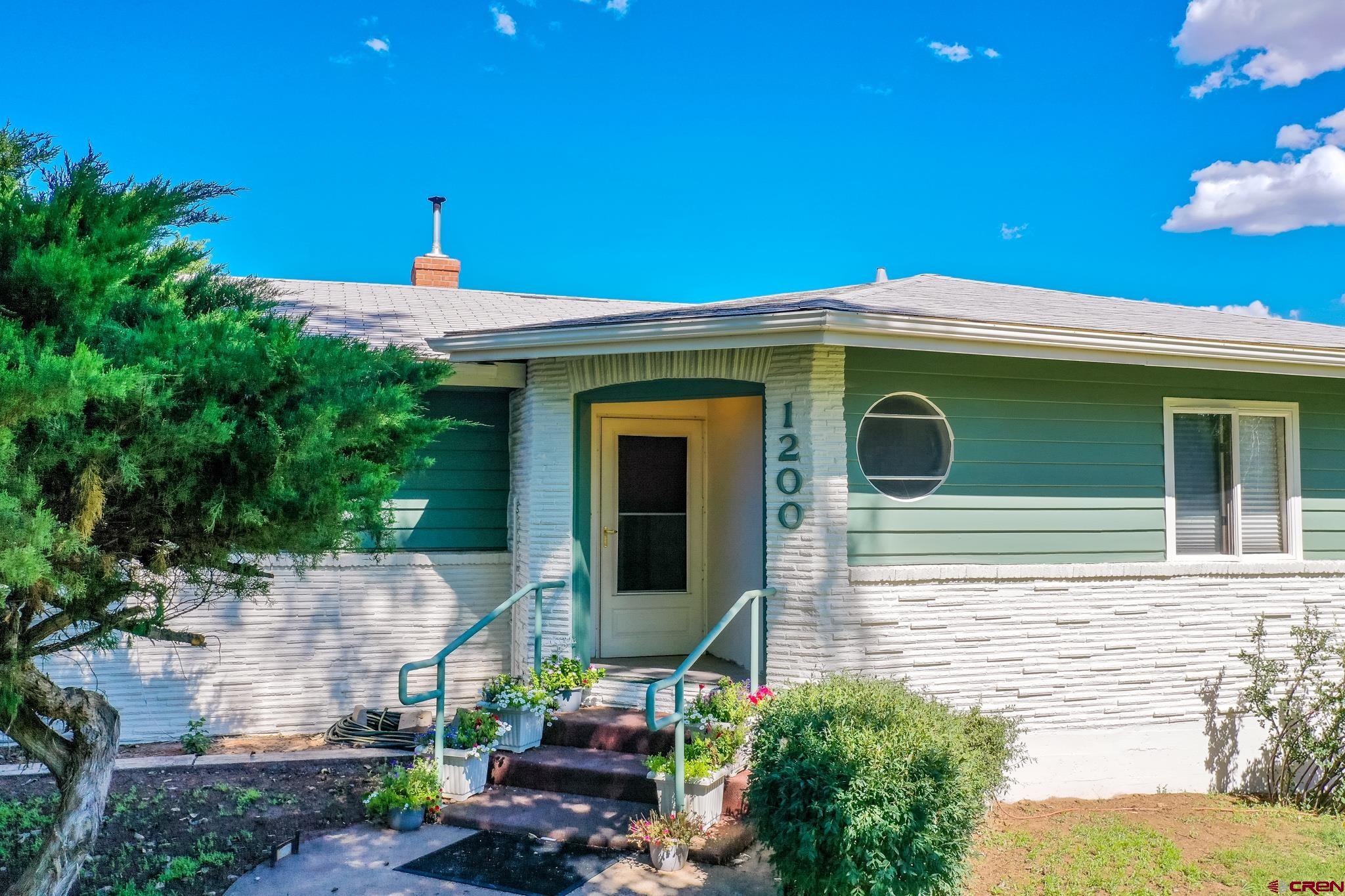 1200 North Dolores Road Cortez, CO 81321 - Photo 10 of 34 a front view of a house with plants