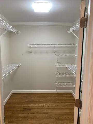 a view of walk in closet with empty racks