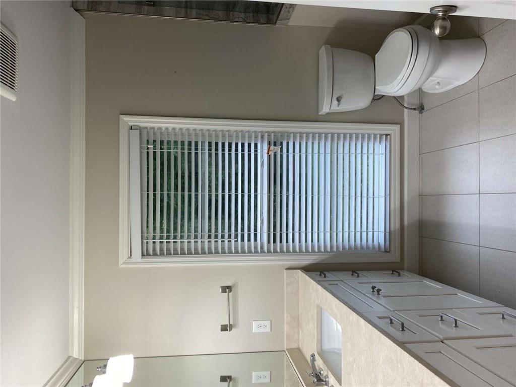 2021 Woodbine Terrace Northeast Atlanta, GA 30329 - Photo 13 of 24 a bathroom with a granite countertop toilet a sink and a mirror