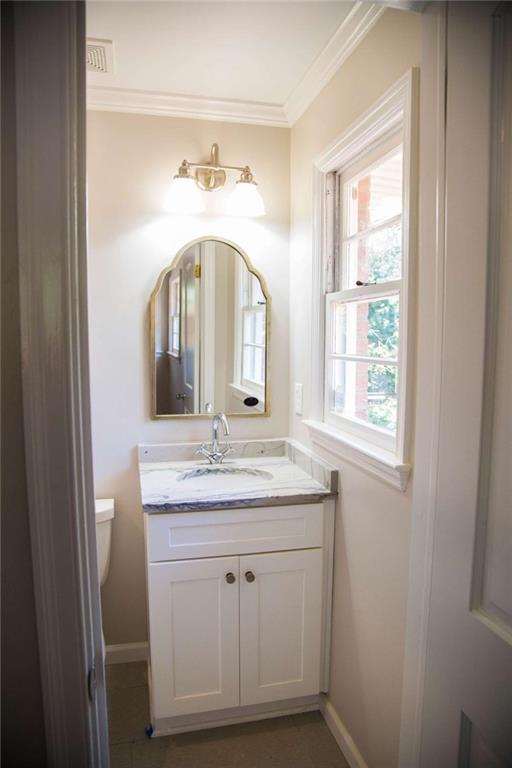 2021 Woodbine Terrace Northeast Atlanta, GA 30329 - Photo 16 of 24 a bathroom with a granite countertop sink a mirror and a vanity