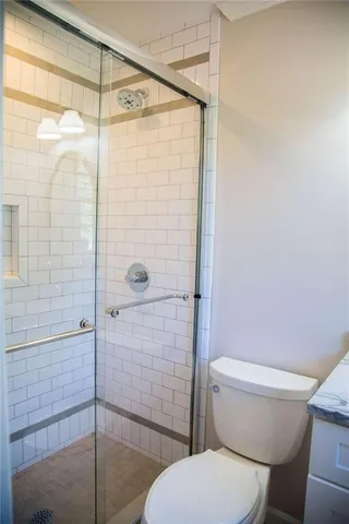 a bathroom with a toilet and a shower
