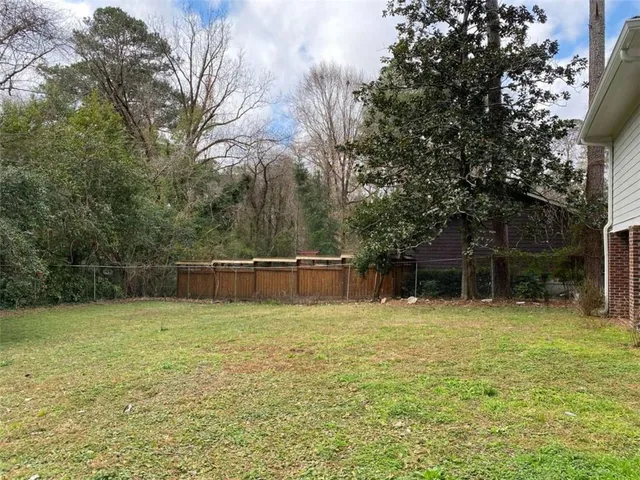 a swimming pool with a bench and trees