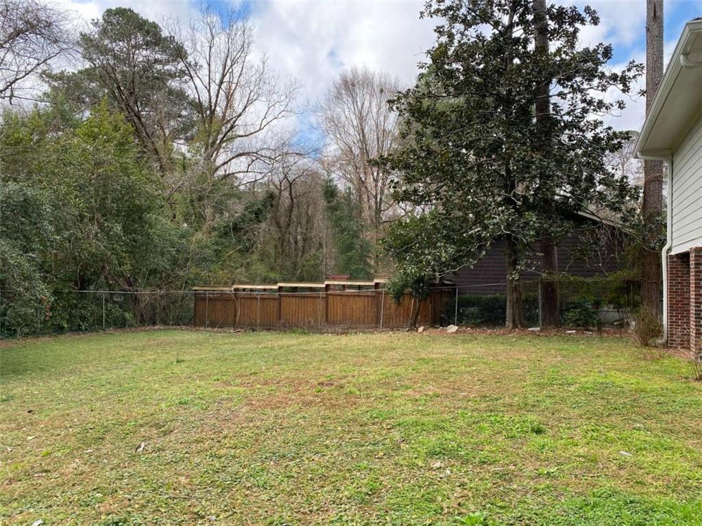 2021 Woodbine Terrace Northeast Atlanta, GA 30329 - Photo 22 of 24 a swimming pool with a bench and trees