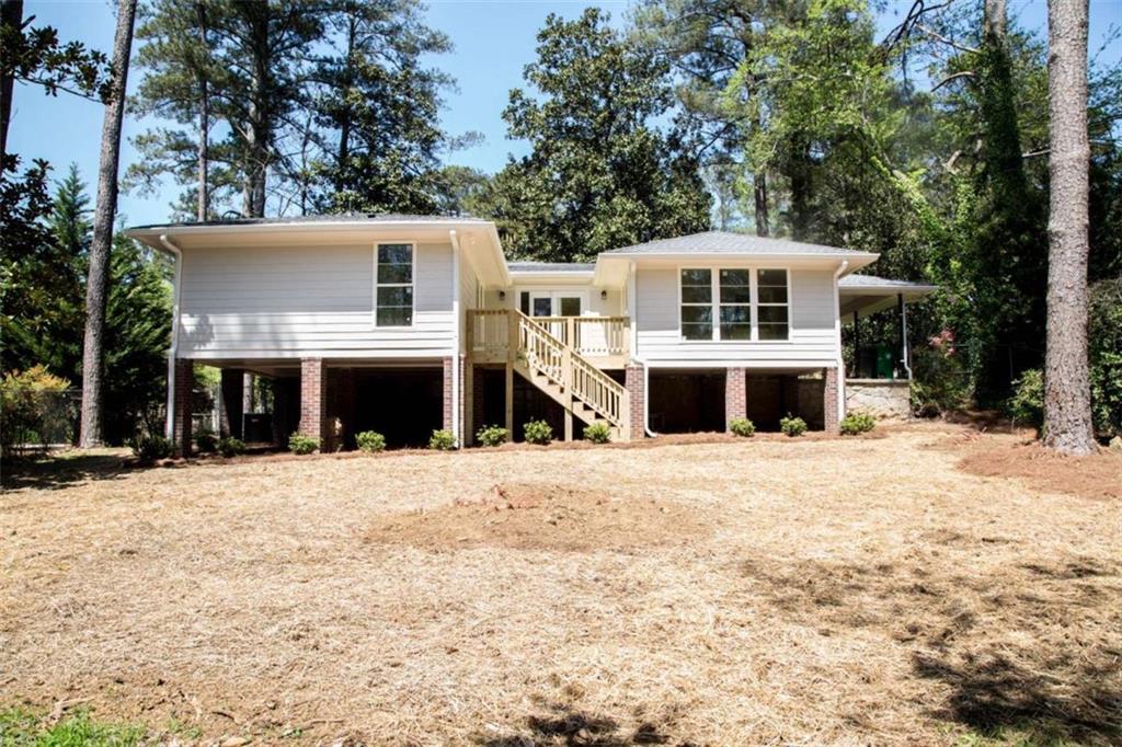 2021 Woodbine Terrace Northeast Atlanta, GA 30329 - Photo 23 of 24 a front view of a house with a yard covered in snow