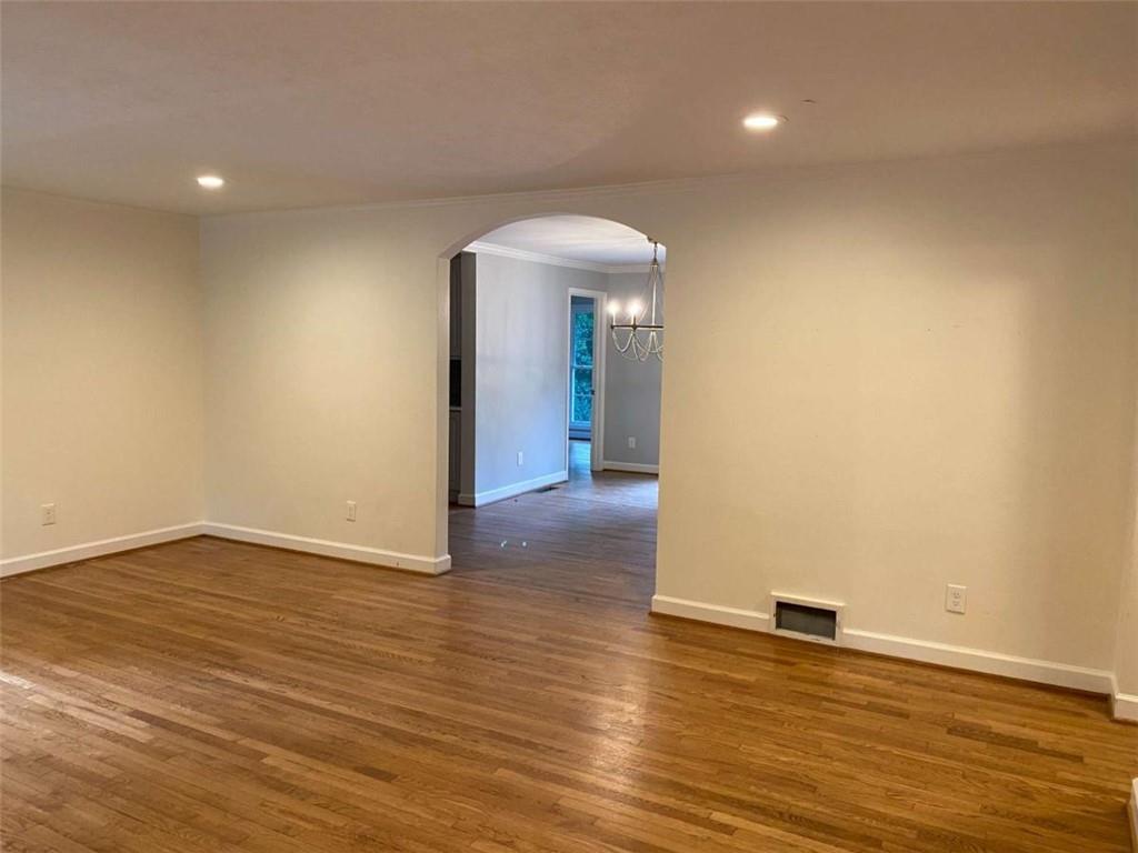 2021 Woodbine Terrace Northeast Atlanta, GA 30329 - Photo 3 of 24 an empty room with wooden floor and a ceiling fan