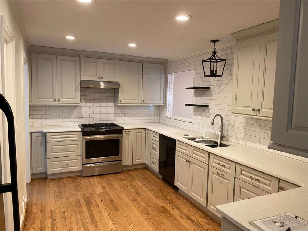 2021 Woodbine Terrace Northeast Atlanta, GA 30329 - Photo 6 of 24 a kitchen with stainless steel appliances granite countertop a sink stove and cabinets