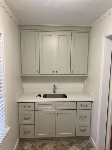 a kitchen with white cabinets and white appliances