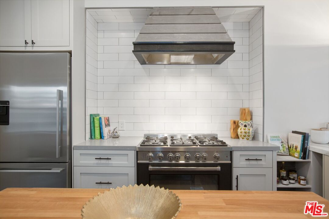 403 North Irving Boulevard Los Angeles, CA 90004 - Photo 14 of 46 a kitchen with a stove and cabinets