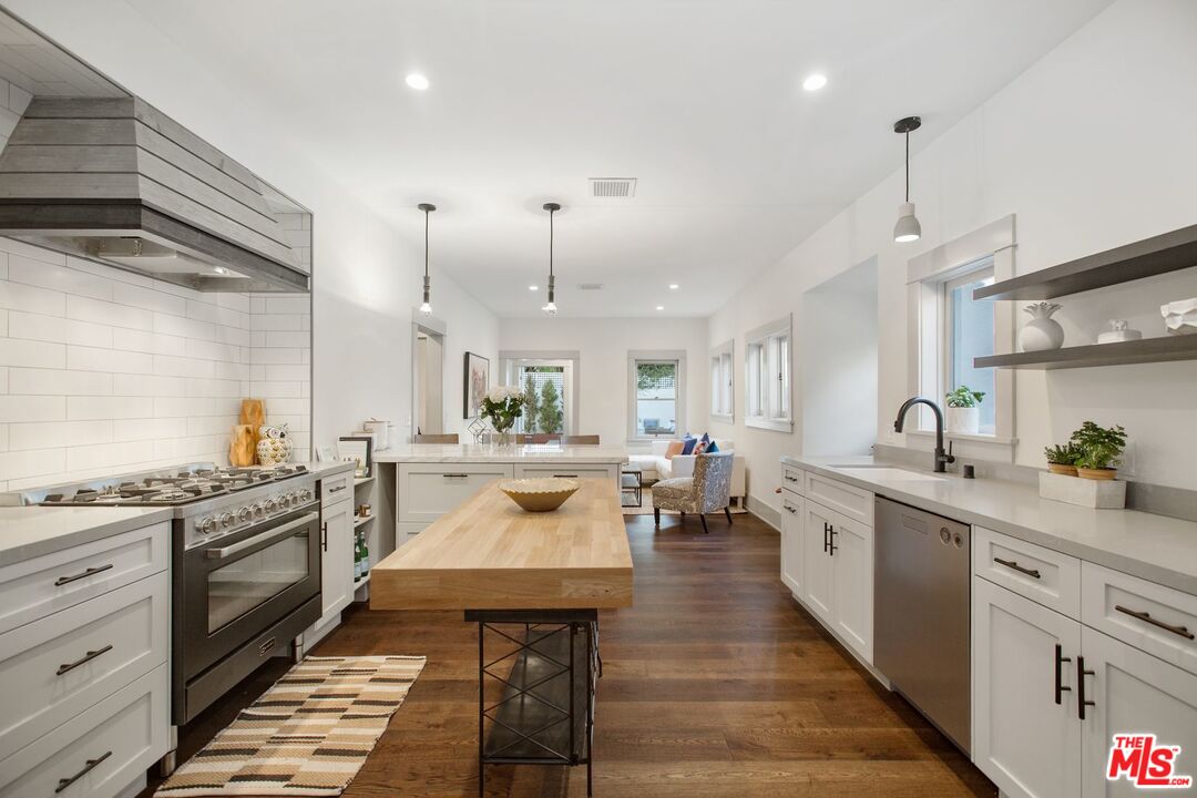 403 North Irving Boulevard Los Angeles, CA 90004 - Photo 15 of 46 a kitchen with a stove a sink and cabinets