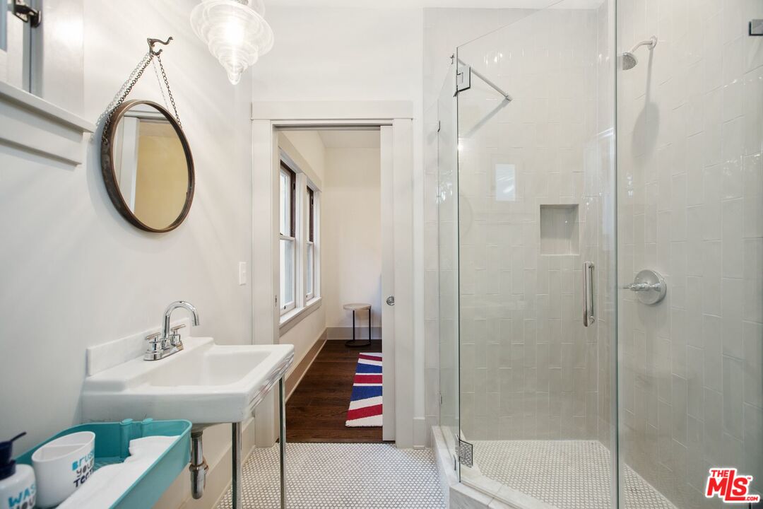 403 North Irving Boulevard Los Angeles, CA 90004 - Photo 19 of 46 a bathroom with a sink a toilet and a mirror