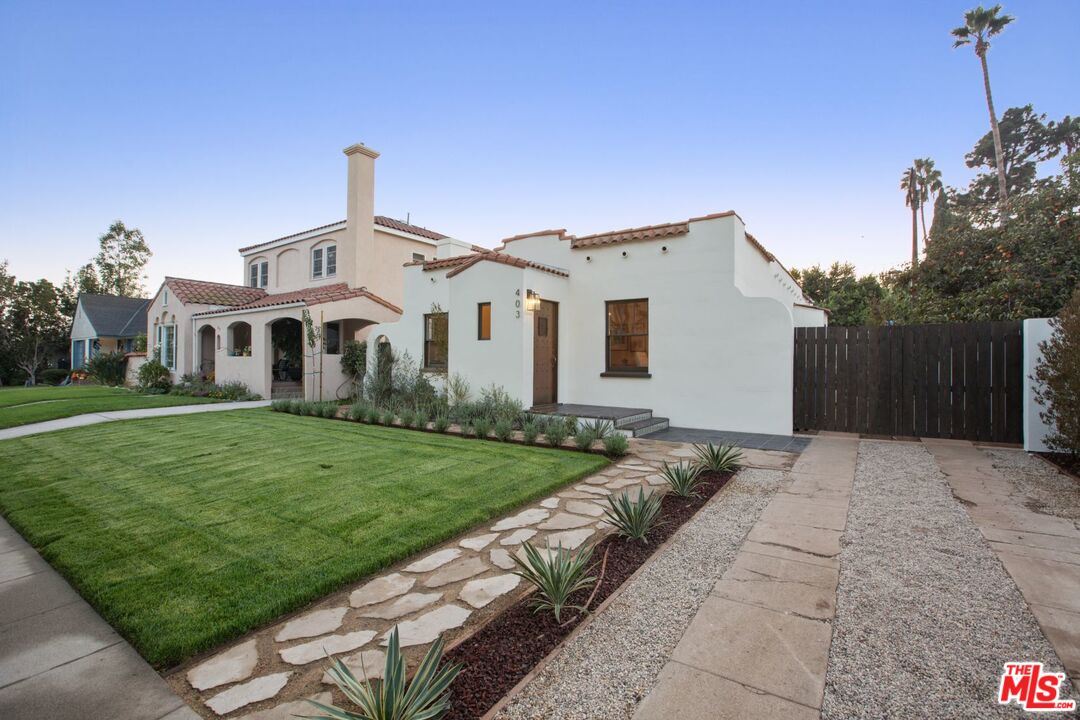 403 North Irving Boulevard Los Angeles, CA 90004 - Photo 3 of 46 a front view of a house with a yard