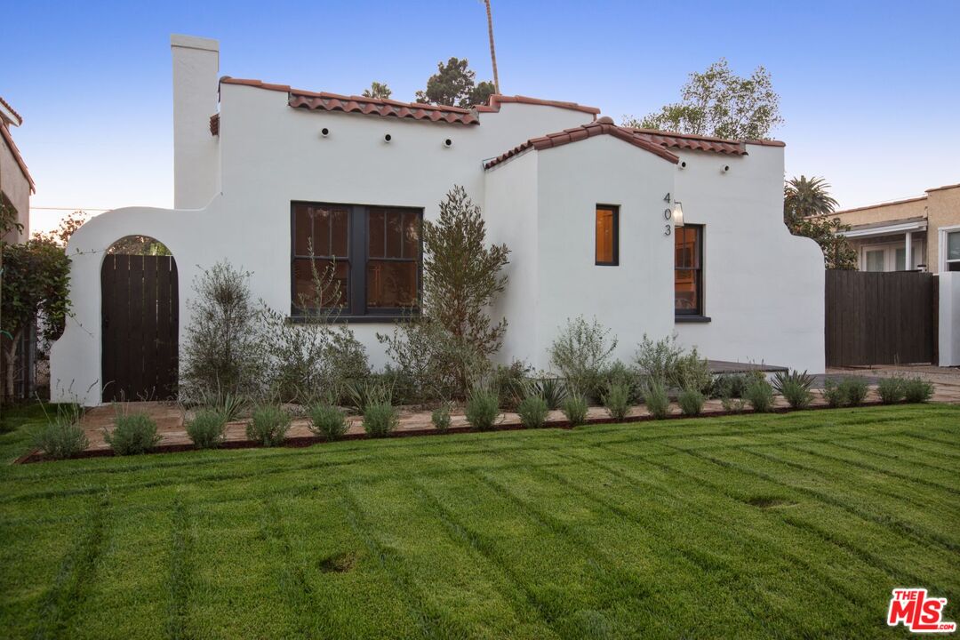 403 North Irving Boulevard Los Angeles, CA 90004 - Photo 4 of 46 a front view of a house with a yard