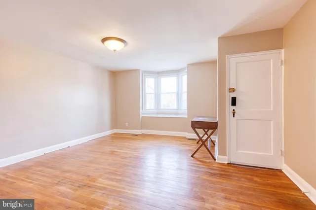 a view of a livingroom with wooden floor and a window