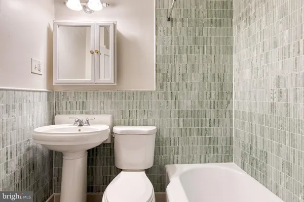 a bathroom with a sink a toilet and mirror