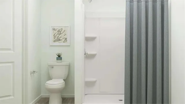 a white toilet sitting next to a bathroom sink