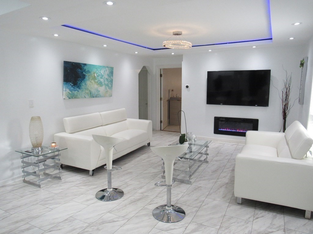 1-3 Walnut Street Methuen, MA 01844 - Photo 2 of 20 a living room with furniture and a flat screen tv