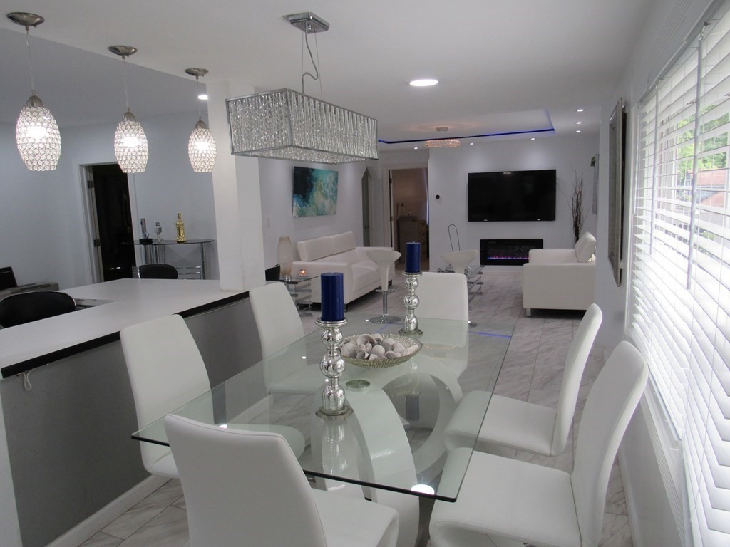 1-3 Walnut Street Methuen, MA 01844 - Photo 5 of 20 a living room with furniture a flat screen tv and a large window