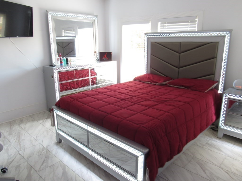 1-3 Walnut Street Methuen, MA 01844 - Photo 9 of 20 a bedroom with a bed and a flat screen tv