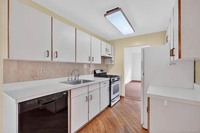 a view of a kitchen with a refrigerator a stove top oven and a dishwasher