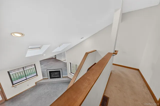 a spacious bedroom with a bed and a lamp