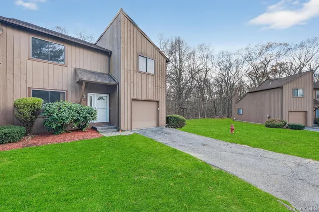 a view of a house with a yard and sitting area