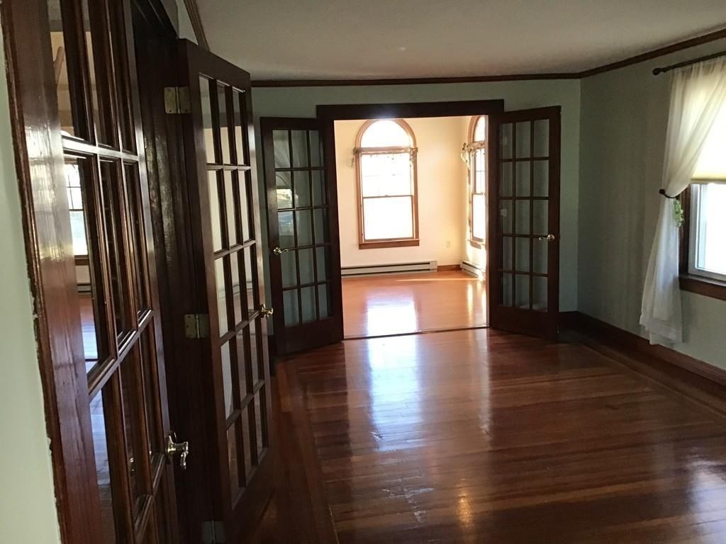 17 Davis Street Taunton, MA 02780 - Photo 12 of 26 wooden floor in an empty room with a window