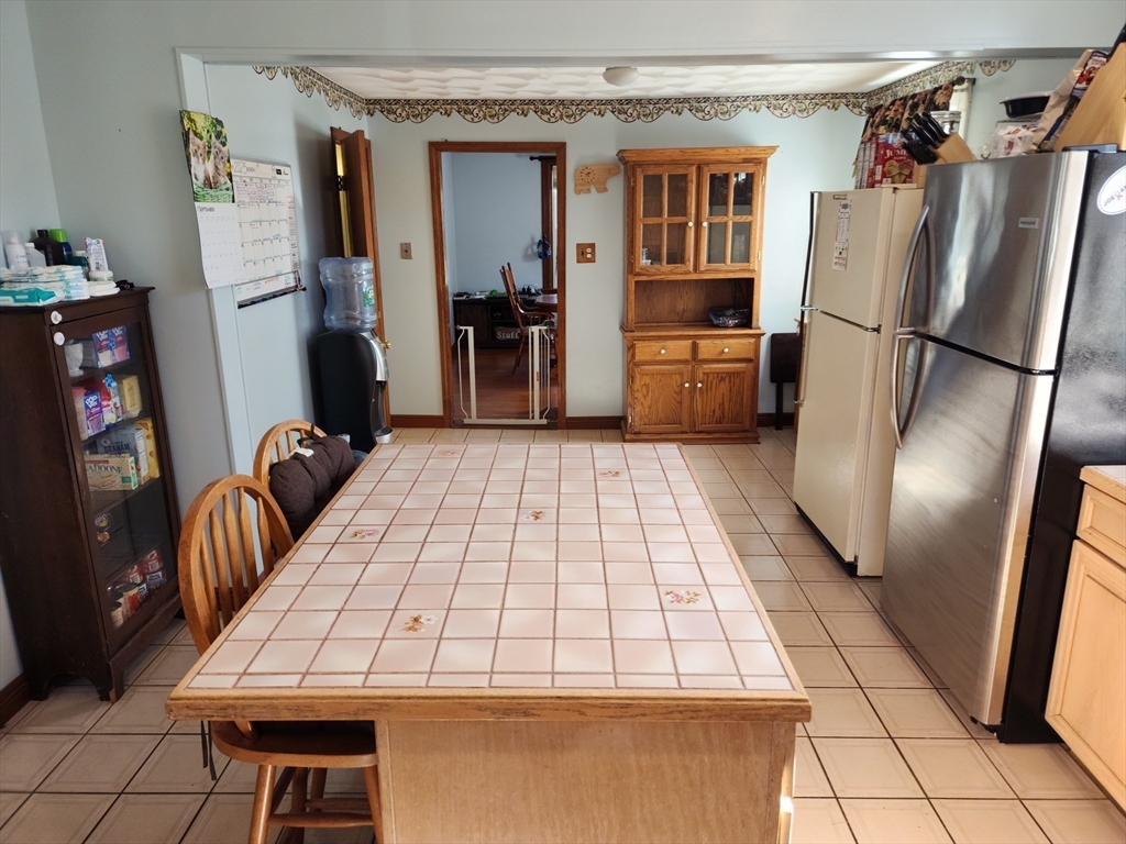 17 Davis Street Taunton, MA 02780 - Photo 16 of 26 a kitchen with a refrigerator and a more cabinets
