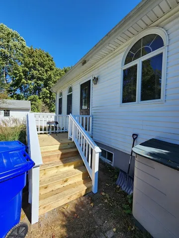 a view of a house with backyard and furniture