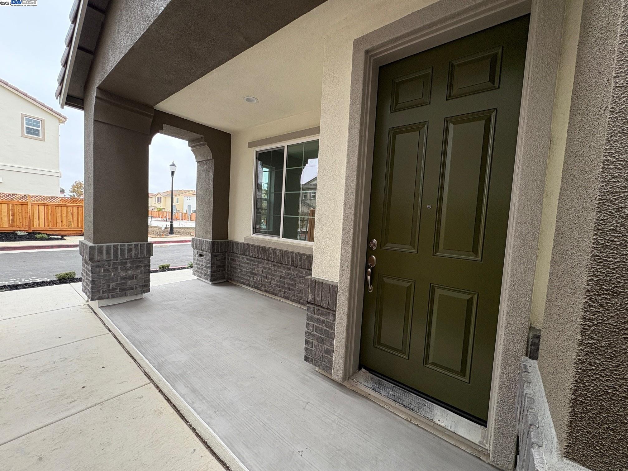 a view of a hallway with brick walls and windows