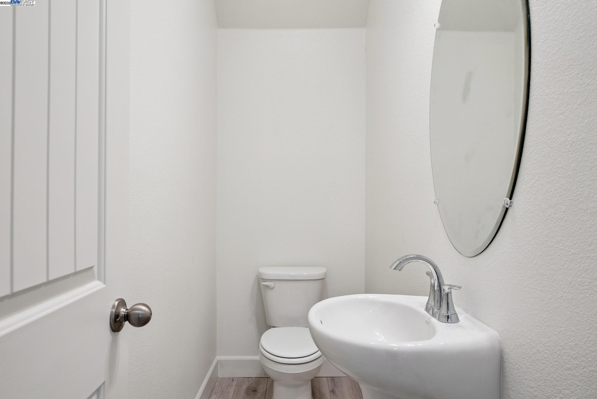246 Mindy Way Pittsburg, CA 94565 - Photo 15 of 38 a bathroom with a toilet sink and mirror