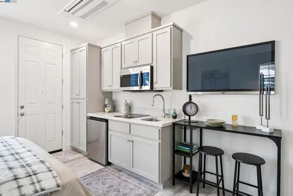 a kitchen with stainless steel appliances a stove a sink and a microwave