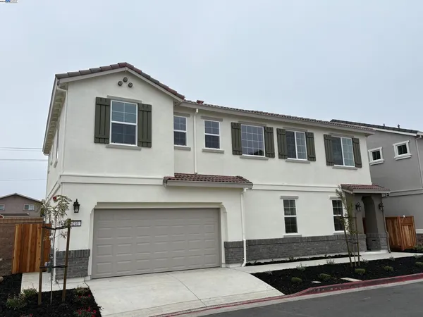 a front view of a house with garage