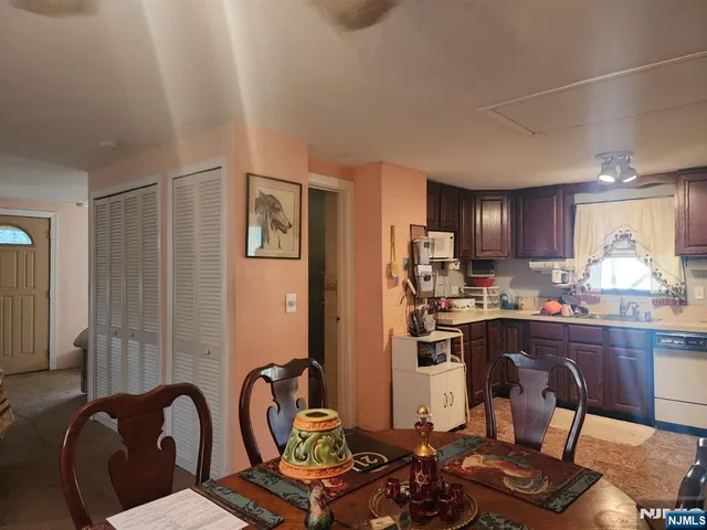 a kitchen with a refrigerator and a stove top oven