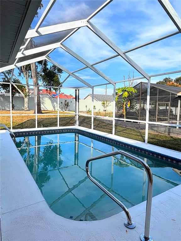 1503 Overland Drive Spring Hill, FL 34608 - Photo 20 of 20 a view of a swimming pool with a lounge chairs