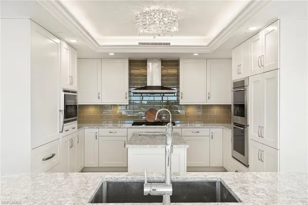 a dining room with furniture wooden floor and a chandelier