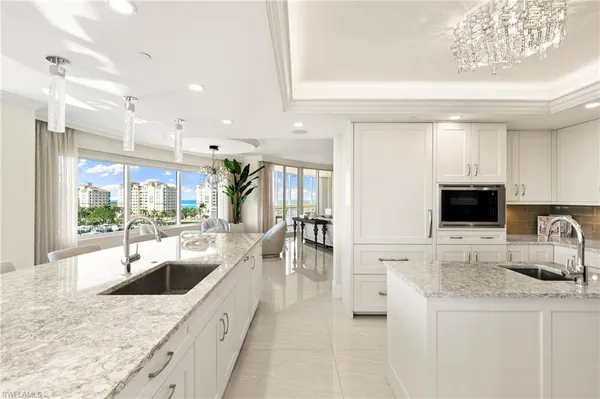 a kitchen with a large window and kitchen view