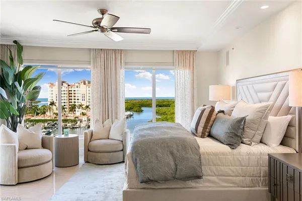 a living room with furniture a rug and a floor to ceiling window