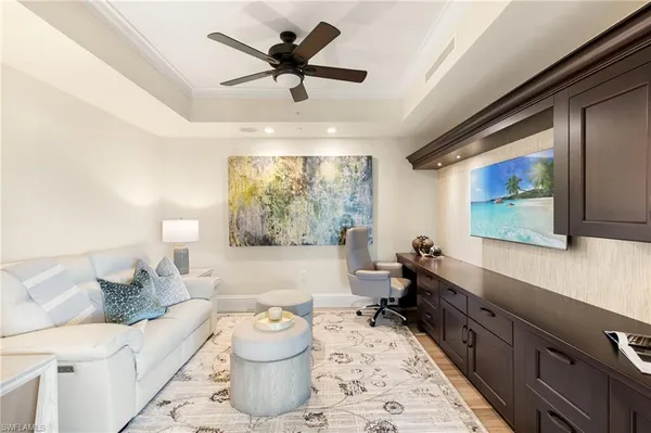a living room with furniture and a chandelier
